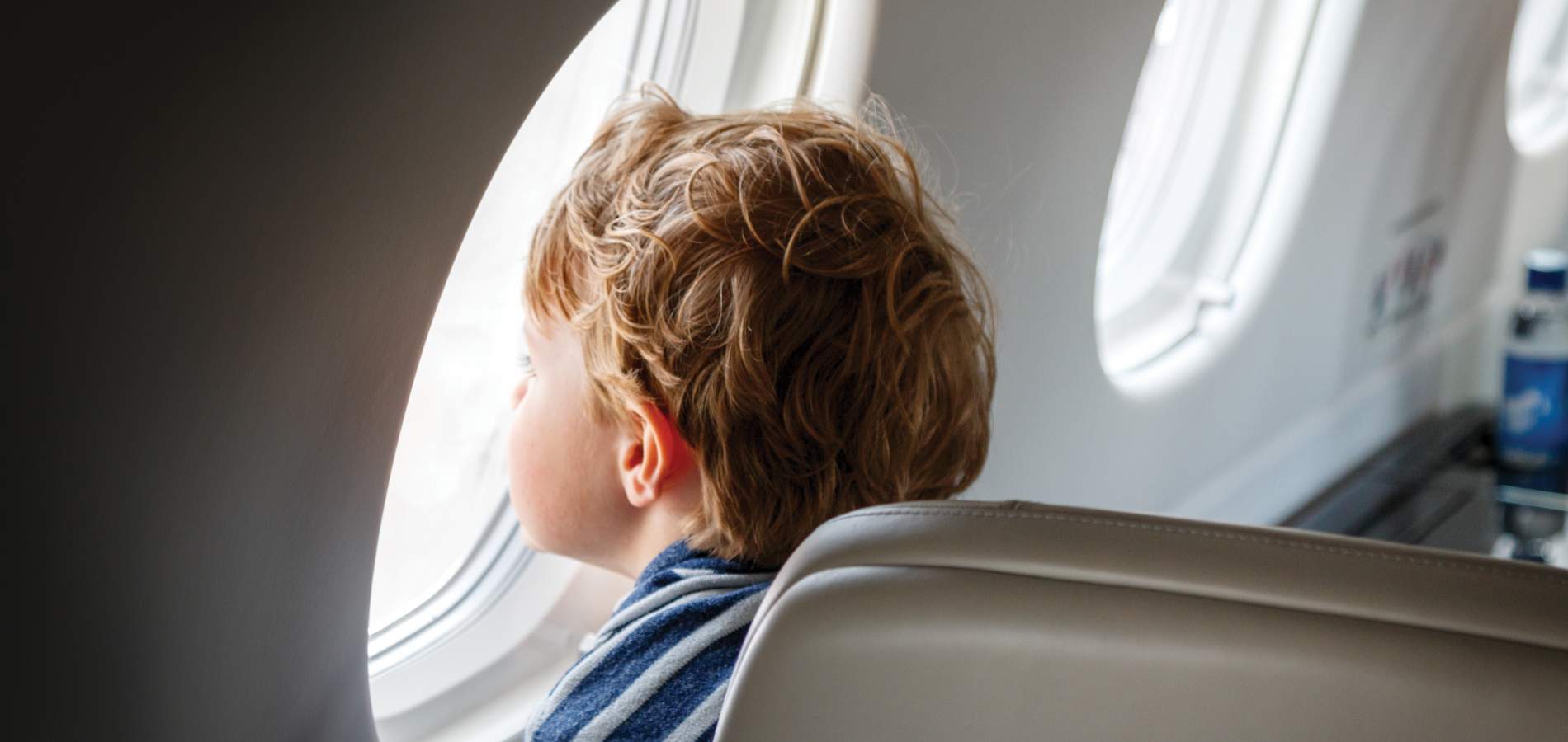 AirSprint child passenger looking outside of window