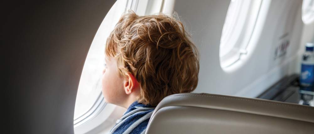 AirSprint child passenger looking outside of window