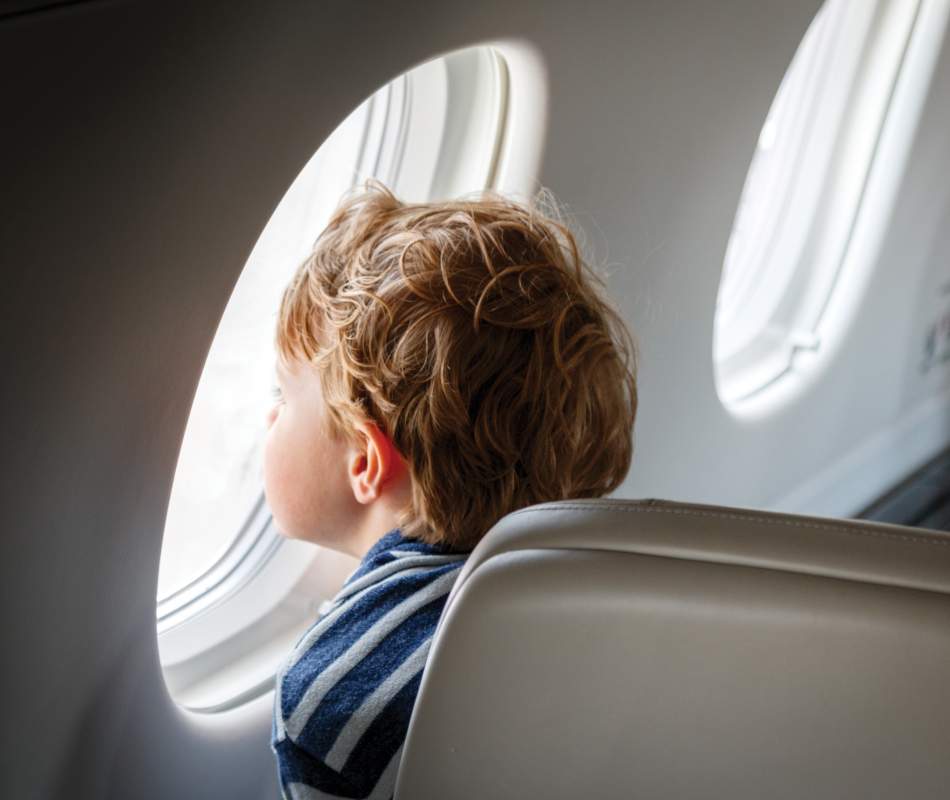 AirSprint child passenger looking outside of window